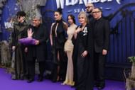 (Left to right) Isaac Ordonez, Luis Guzmán, Catherine Zeta-Jones, Jenna Ortega, Joanna Lumley, Fred Armisen, and Victor Dorobantu at Wednesday Season 2, Part 1 Global Premiere (Image via Getty)